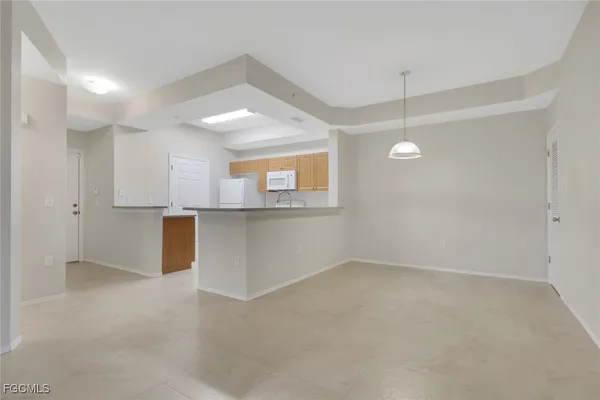 an empty room with a kitchen and a sink