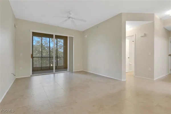 an empty room with wooden floor and sliding door