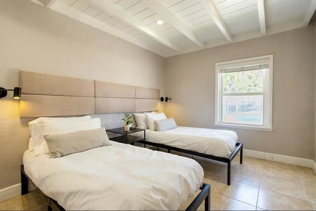 a living room with furniture a large window with wooden floor