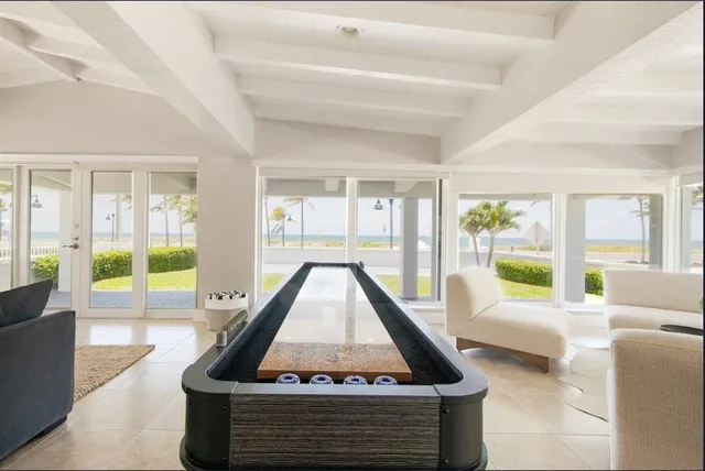 a room with furniture pool table and flat screen tv