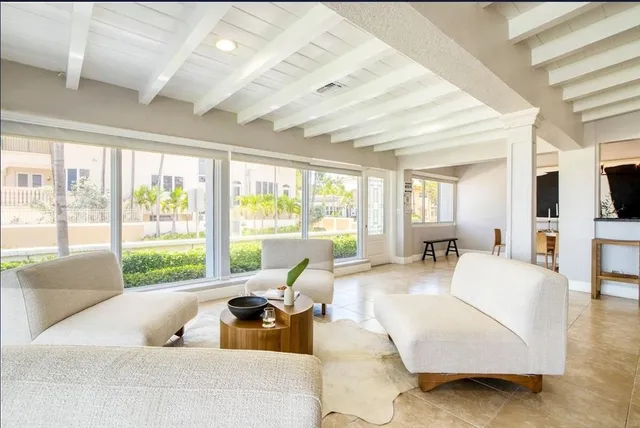 a living room with furniture wooden floor and a large window