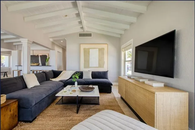 a kitchen with granite countertop a sink stove and microwave