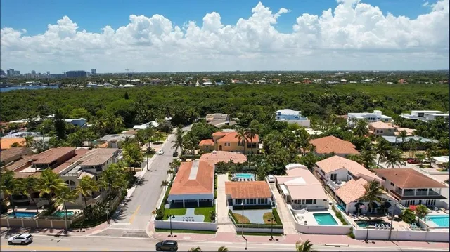 a kitchen with stainless steel appliances granite countertop a refrigerator a stove a sink and a microwave