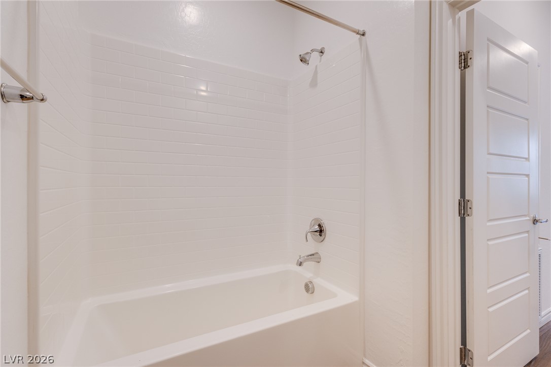 2555 Hampton Road, Unit 8206 Henderson, NV 89052 - Photo 21 of 25 A pristine white bathtub and shower combo offers a clean, functional bathing space.