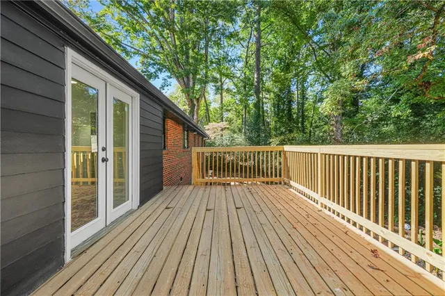 a view of backyard with a deck and wooden floor