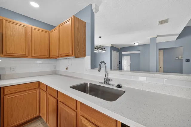 a kitchen with a sink cabinets and stainless steel appliances