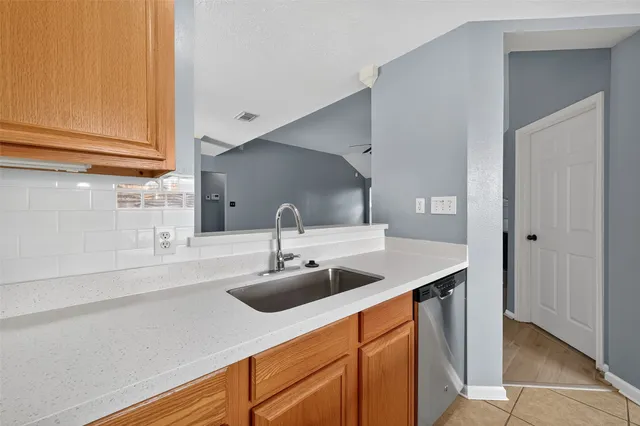 a kitchen with stainless steel appliances a sink and a cabinets