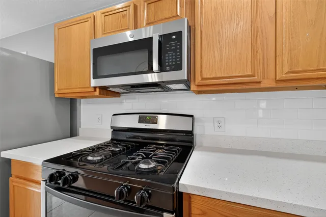 a kitchen with wooden floor and steel stainless steel appliances