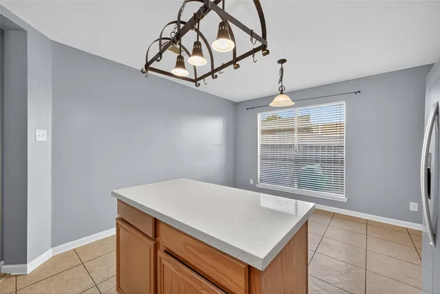 a view of a room with a ceiling fan and window