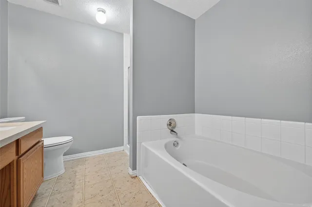a bathroom with a bathtub and toilet