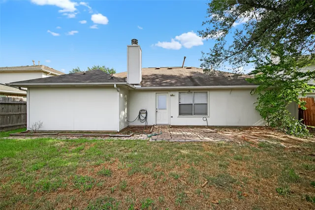 a front view of a house with a garden and yard