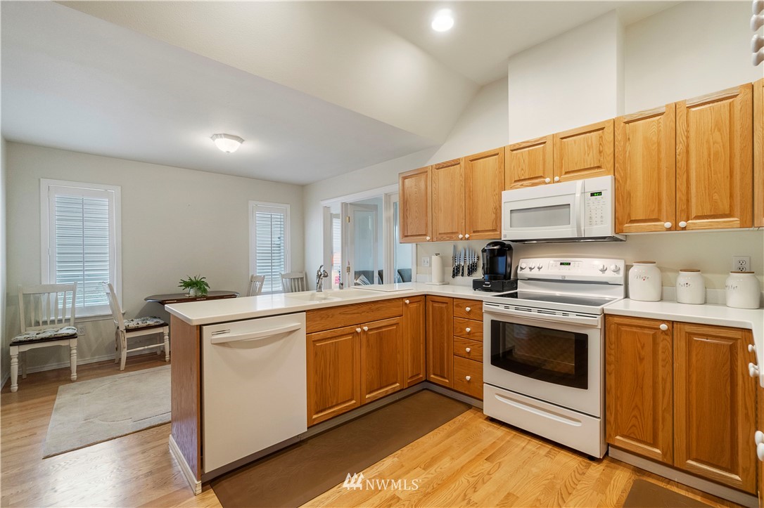 1488 Mountain View Drive, Unit 4 Enumclaw, WA 98022 - Photo 6 of 20 a kitchen with stainless steel appliances granite countertop a stove sink and cabinets