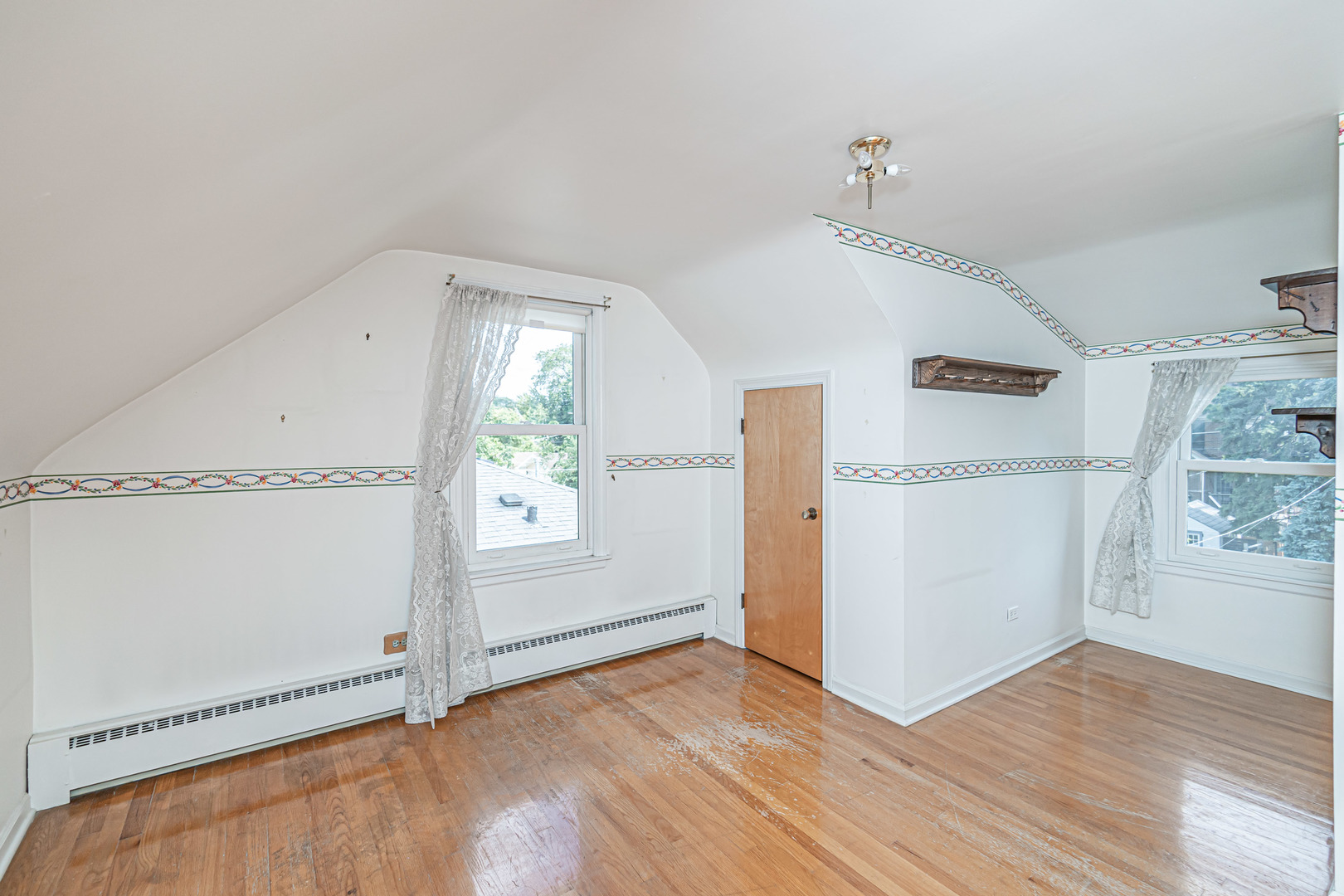 1001 Oakton Street Park Ridge, IL 60068 - Photo 14 of 33 an empty room with wooden floor and windows