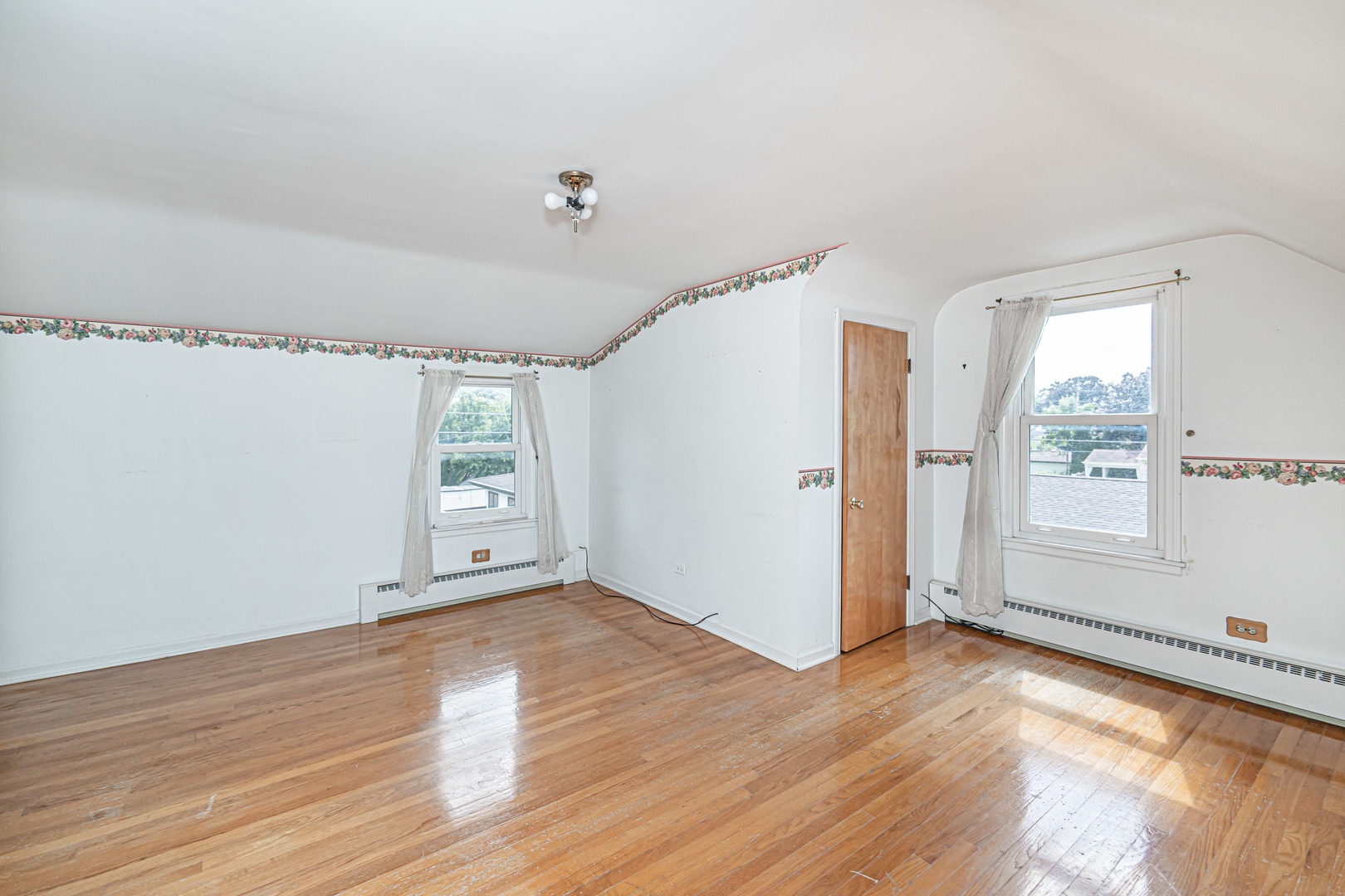1001 Oakton Street Park Ridge, IL 60068 - Photo 16 of 33 an empty room with wooden floor and windows