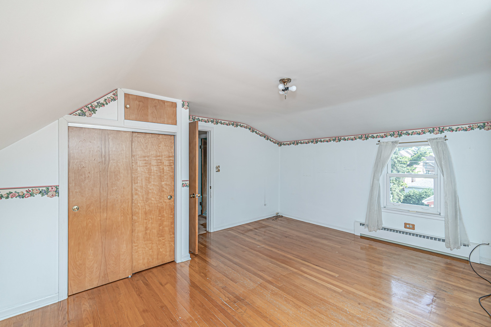 1001 Oakton Street Park Ridge, IL 60068 - Photo 17 of 33 a view of empty room with wooden floor and fan