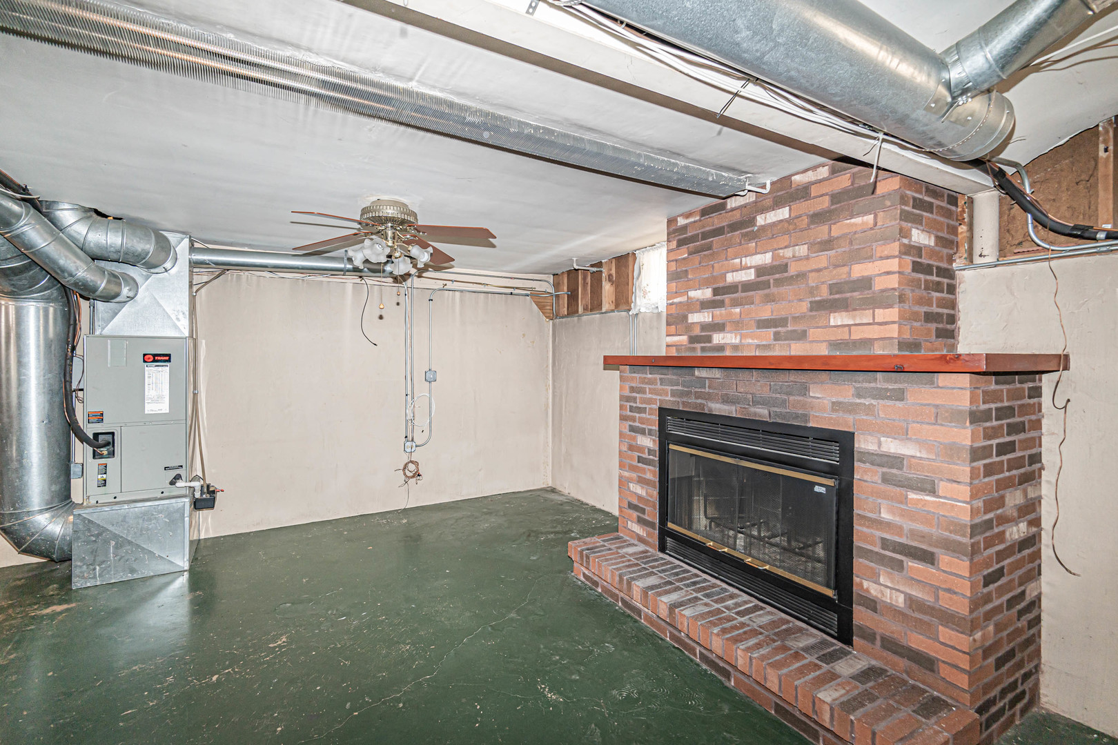 1001 Oakton Street Park Ridge, IL 60068 - Photo 21 of 33 a living room with a fireplace and a ceiling fan
