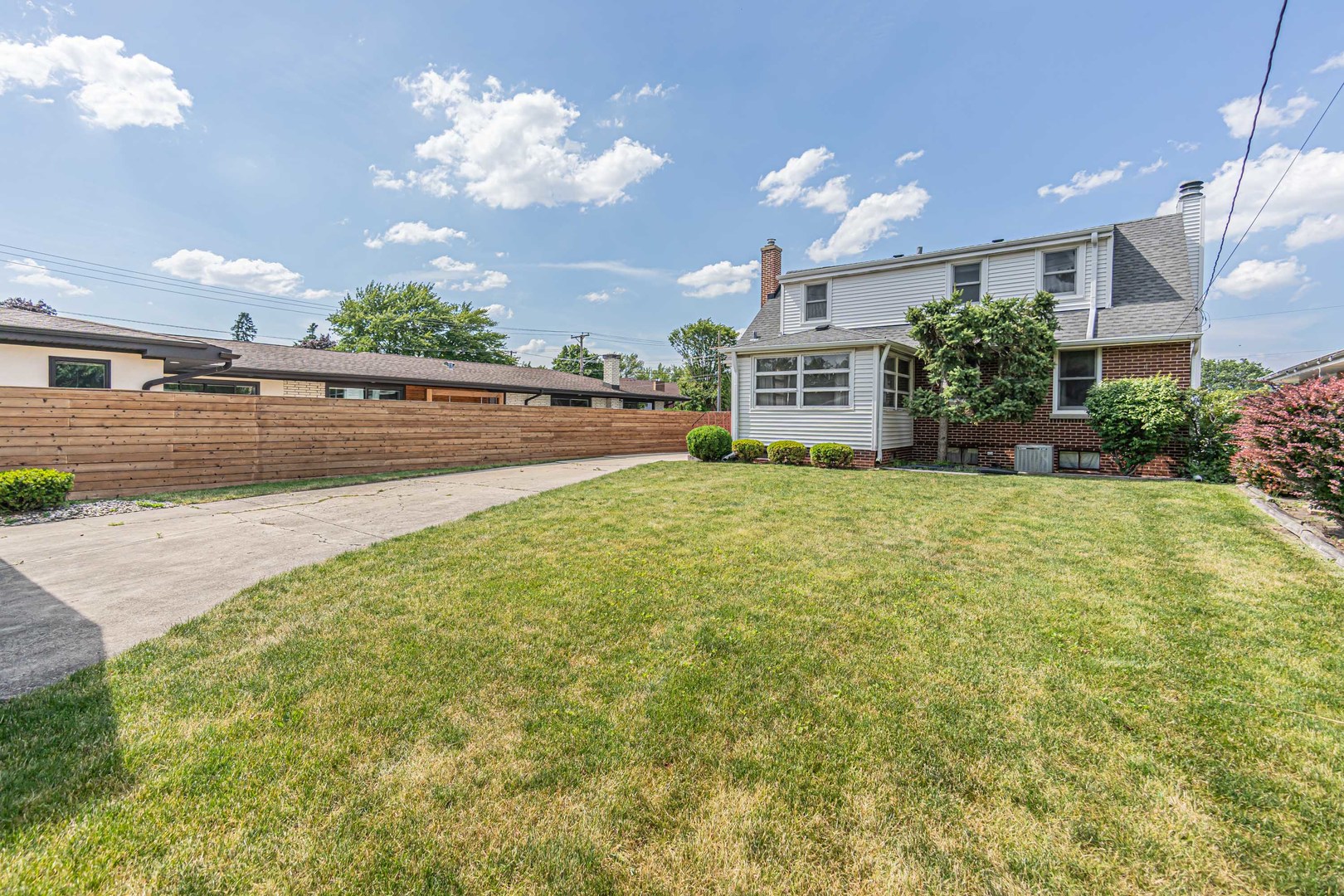 1001 Oakton Street Park Ridge, IL 60068 - Photo 25 of 33 a view of a house with a big yard and potted plants