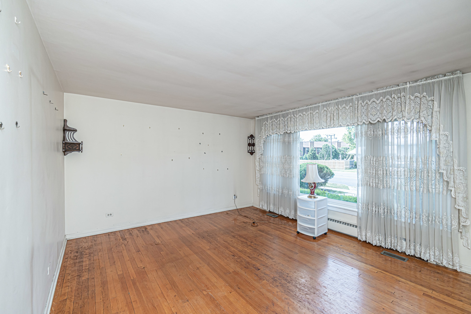 1001 Oakton Street Park Ridge, IL 60068 - Photo 3 of 33 an empty room with wooden floor and windows