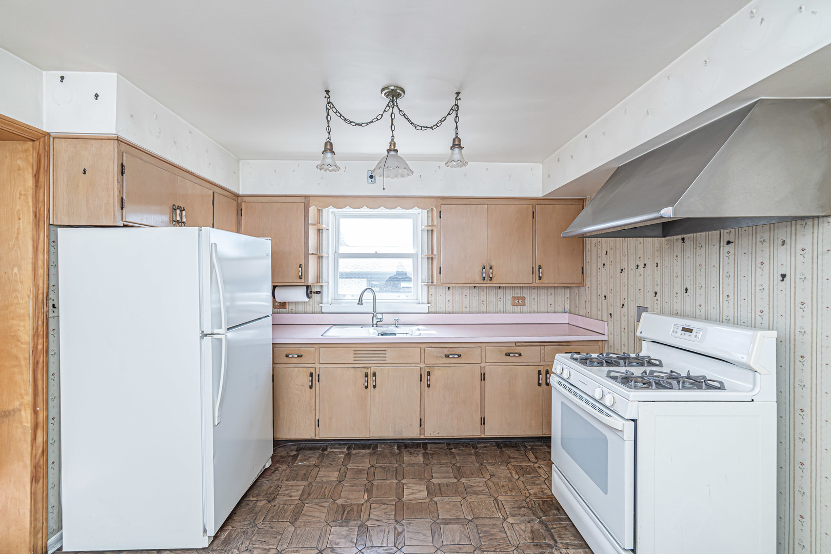 1001 Oakton Street Park Ridge, IL 60068 - Photo 7 of 33 a kitchen with a sink a refrigerator and white cabinets