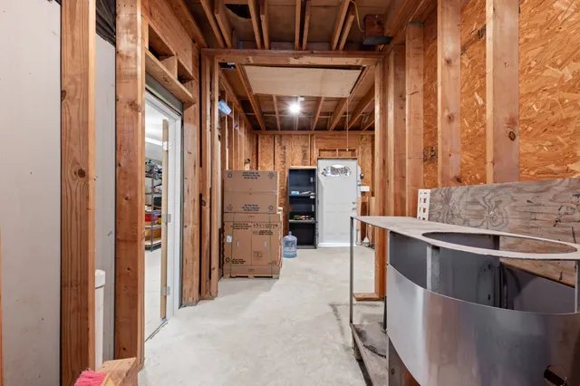 a view of empty room with refrigerator