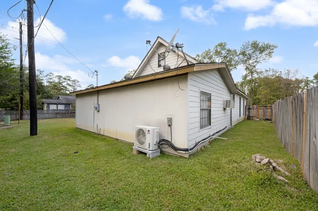 a backyard of a house with table and chairs