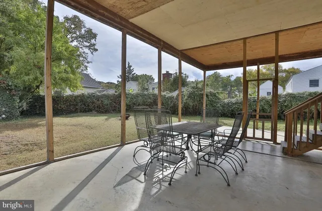 a view of a porch with chairs and backyard