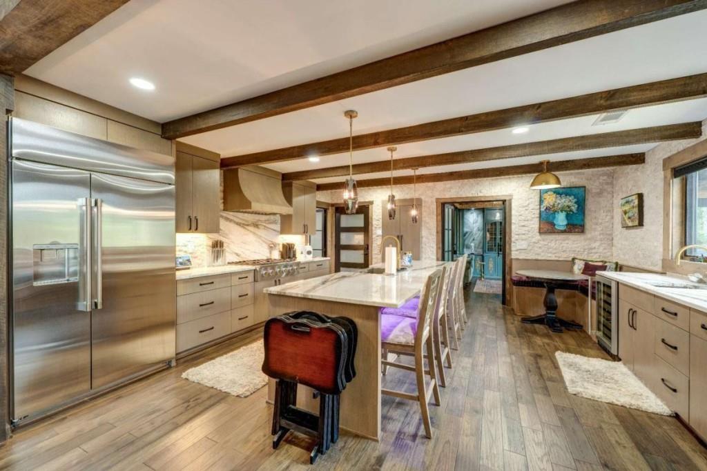 312 Charles Road Ellijay, GA 30540 - Photo 14 of 47 a dining hall with stainless steel appliances kitchen island granite countertop a table chairs and a glass door