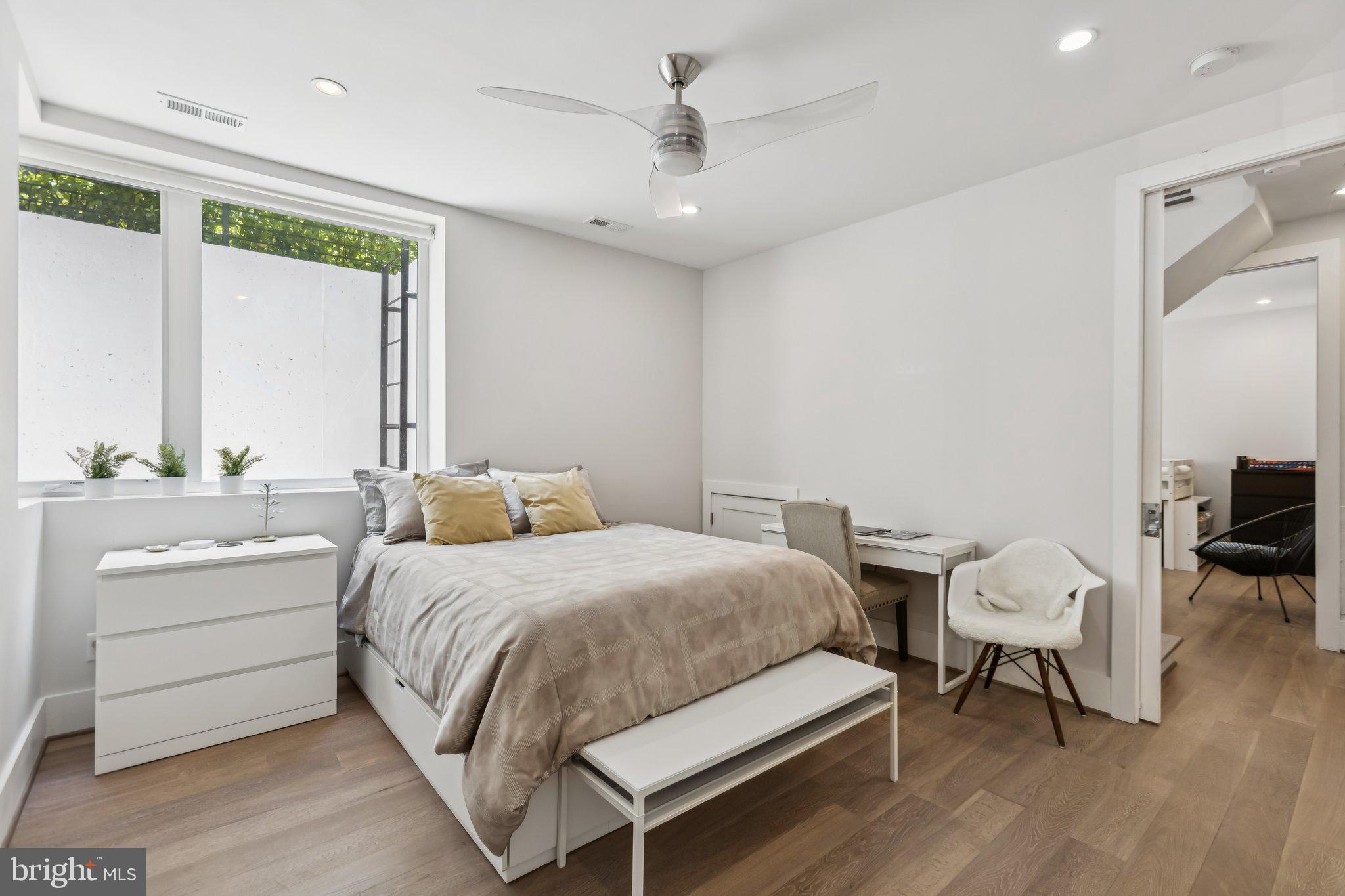 3919 Fulton Street Northwest, Unit 4 Washington, DC 20007 - Photo 19 of 31 a bedroom with a bed and a table