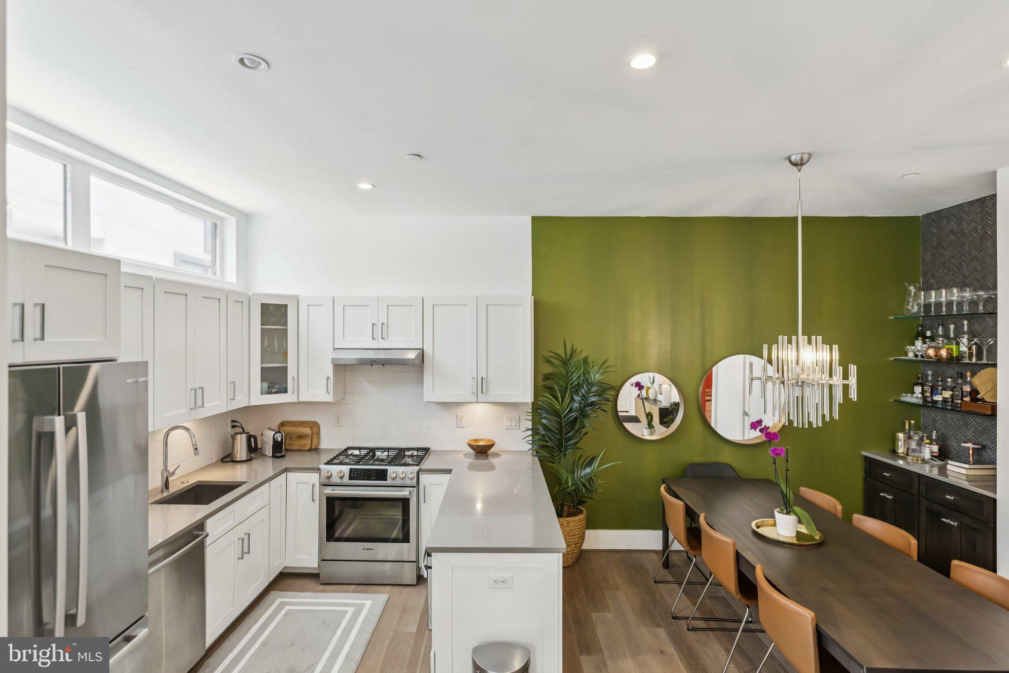 3919 Fulton Street Northwest, Unit 4 Washington, DC 20007 - Photo 7 of 31 a kitchen with stainless steel appliances granite countertop a stove a sink and a refrigerator