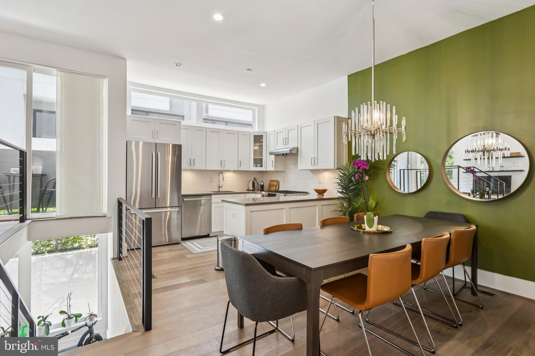 3919 Fulton Street Northwest, Unit 4 Washington, DC 20007 - Photo 8 of 31 a kitchen with stainless steel appliances granite countertop a stove a refrigerator a microwave a dining table and chairs