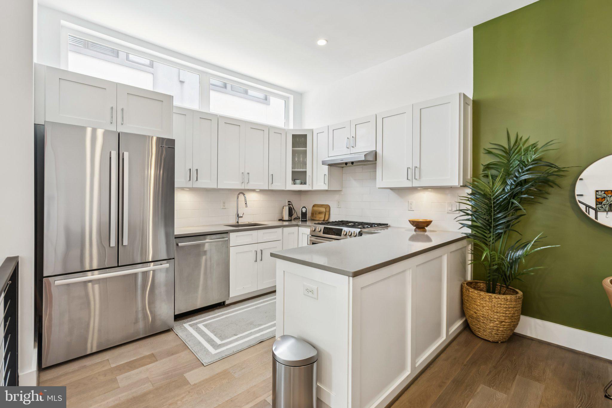 3919 Fulton Street Northwest, Unit 4 Washington, DC 20007 - Photo 10 of 31 a kitchen with a sink appliances and cabinets