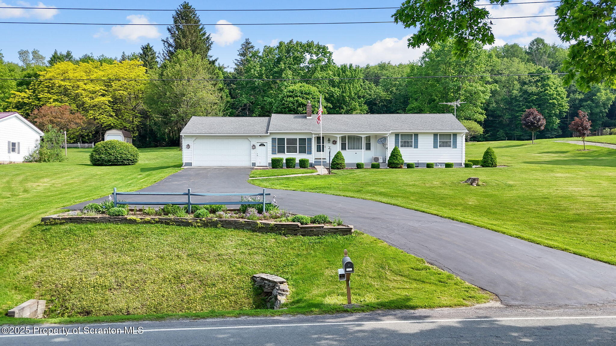 3374 Ridge Road Montrose, PA 18801 - Photo 1 of 31 a front view of a house with a garden