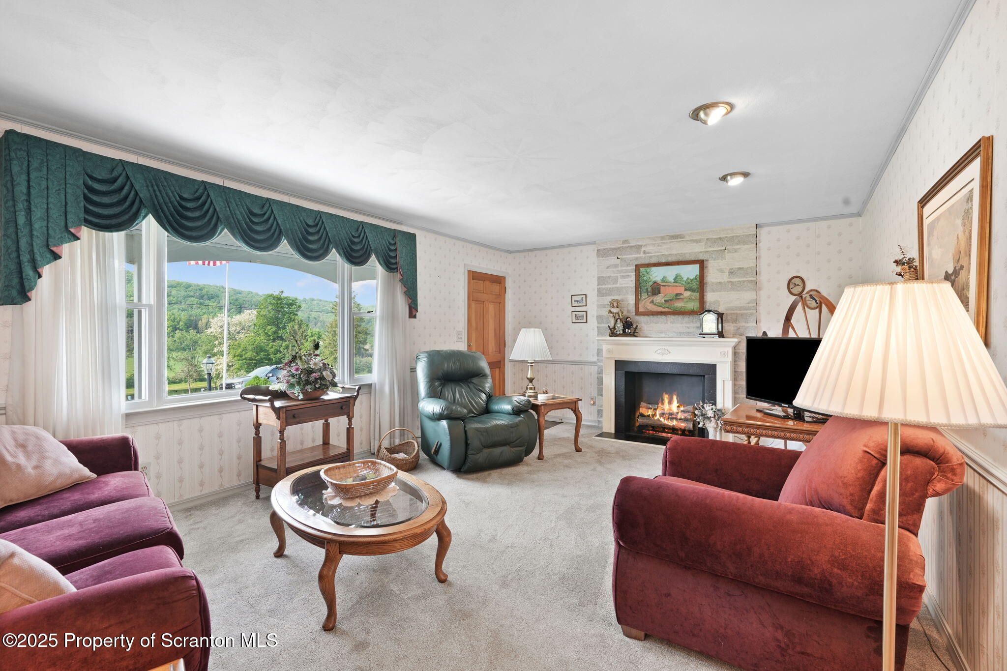 3374 Ridge Road Montrose, PA 18801 - Photo 12 of 31 a living room with furniture a fireplace and a large window