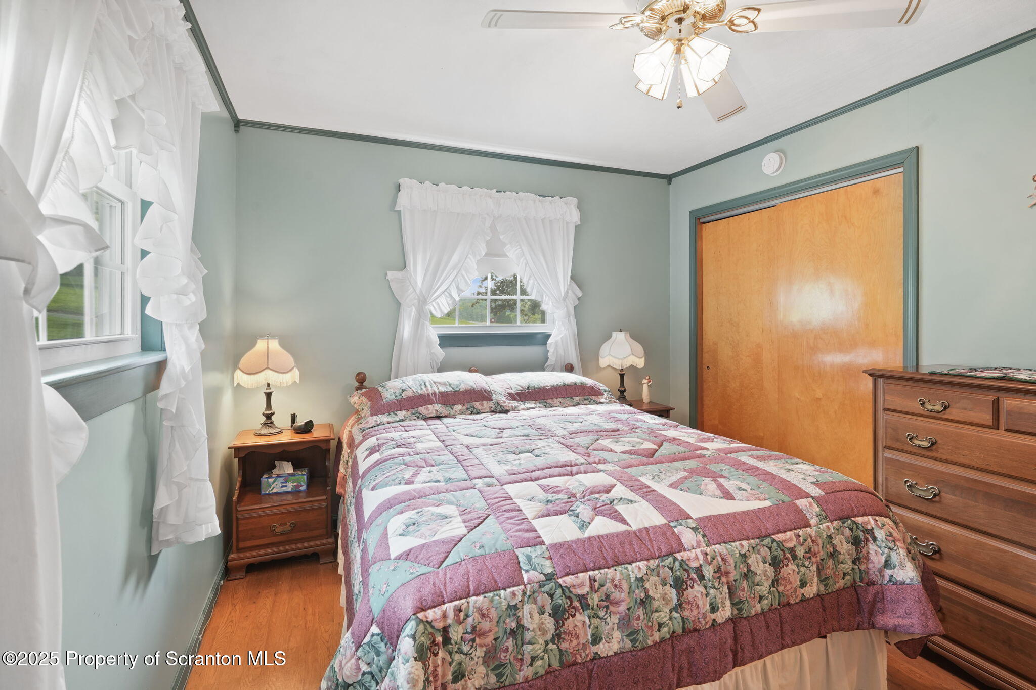 3374 Ridge Road Montrose, PA 18801 - Photo 18 of 31 a bedroom with a bed and a chandelier
