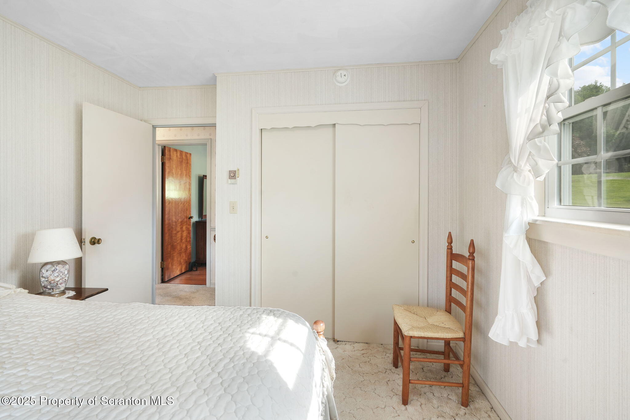 3374 Ridge Road Montrose, PA 18801 - Photo 20 of 31 a bedroom with a bed a chair and a large mirror