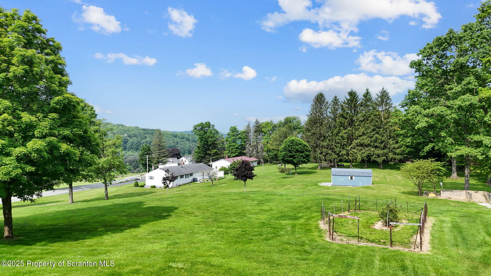 3374 Ridge Road Montrose, PA 18801 - Photo 6 of 31 a view of a golf course with a house in the background