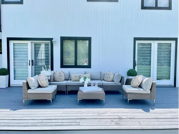 a living room with couches and a potted plant on coffee table
