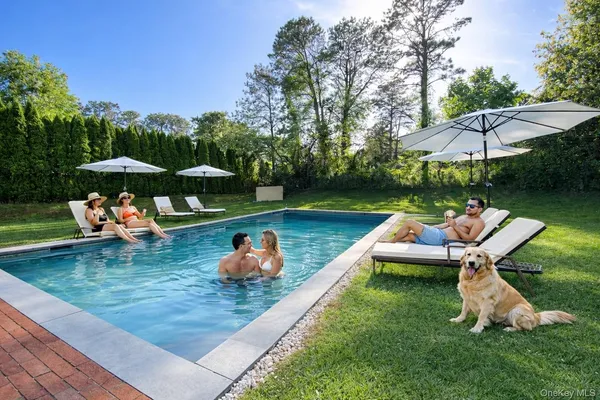 an outdoor sitting area with furniture and umbrella