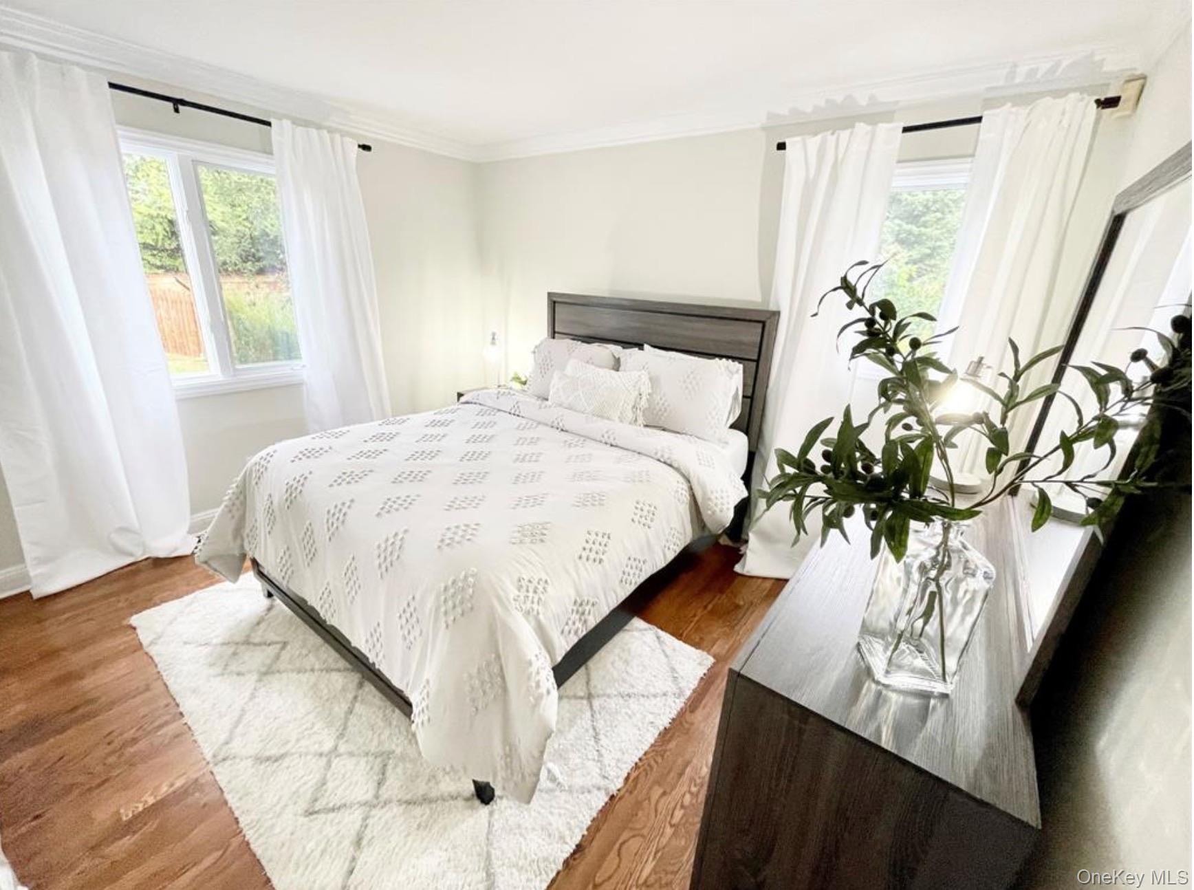 51 Cheviot Road Southampton, NY 11968 - Photo 6 of 22 a bedroom with a bed and a window