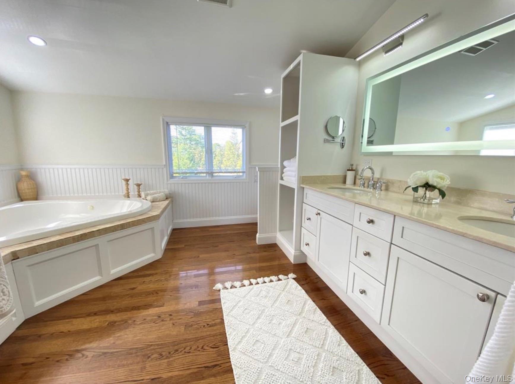 51 Cheviot Road Southampton, NY 11968 - Photo 10 of 22 a spacious bathroom with a double vanity sink and mirror