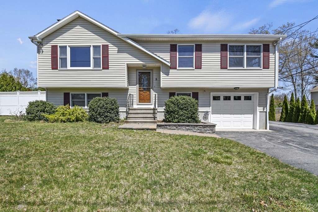 5 Jackson Road Webster, MA 01570 - Photo 1 of 30 a front view of a house with a yard and garage