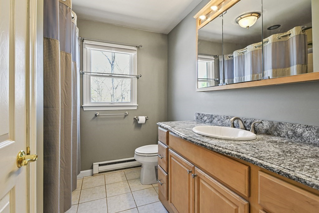 5 Jackson Road Webster, MA 01570 - Photo 16 of 30 a bathroom with a granite countertop double vanity sink a mirror and a toilet