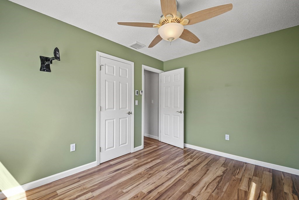 5 Jackson Road Webster, MA 01570 - Photo 18 of 30 wooden floor in an empty room with a chandelier fan