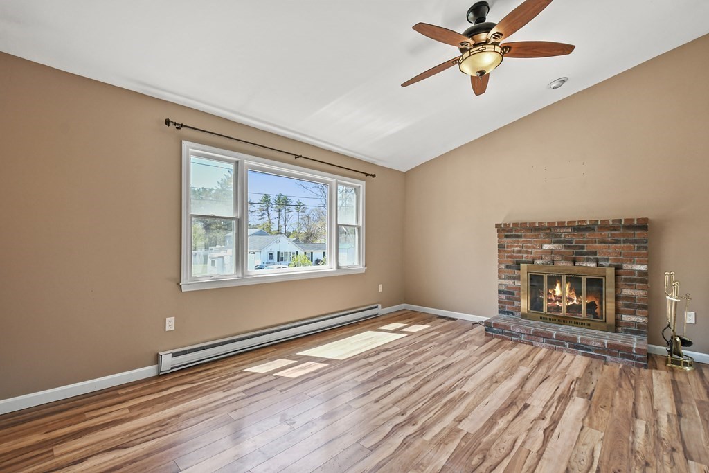 5 Jackson Road Webster, MA 01570 - Photo 2 of 30 a view of an empty room with window and wooden floor