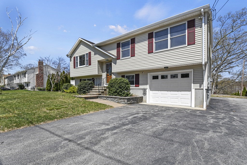 5 Jackson Road Webster, MA 01570 - Photo 22 of 30 a front view of a house with a yard and garage