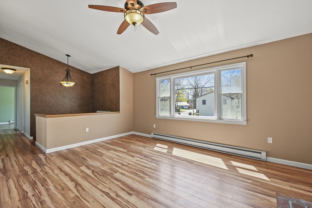 5 Jackson Road Webster, MA 01570 - Photo 3 of 30 a view of an empty room with window and wooden floor
