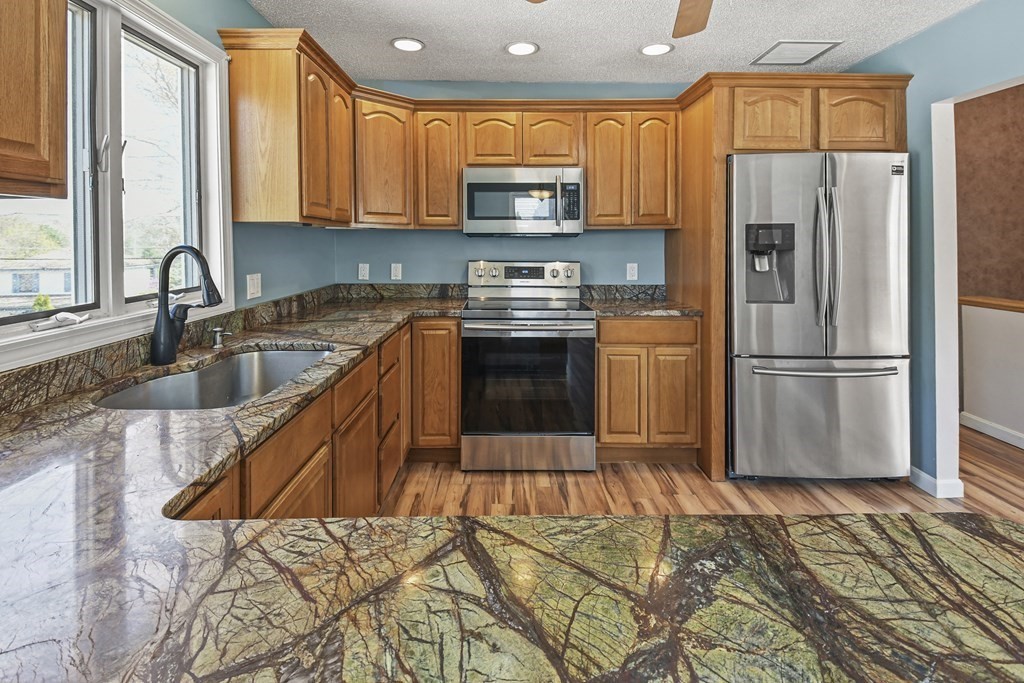 5 Jackson Road Webster, MA 01570 - Photo 6 of 30 a kitchen with granite countertop a refrigerator stove and sink