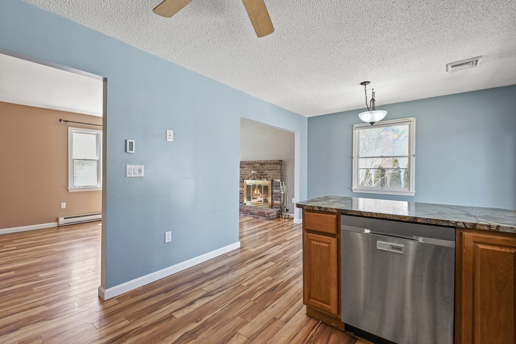 5 Jackson Road Webster, MA 01570 - Photo 9 of 30 a kitchen with granite countertop wooden cabinets and wooden floor