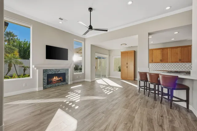 a living room with furniture a fireplace and a flat screen tv