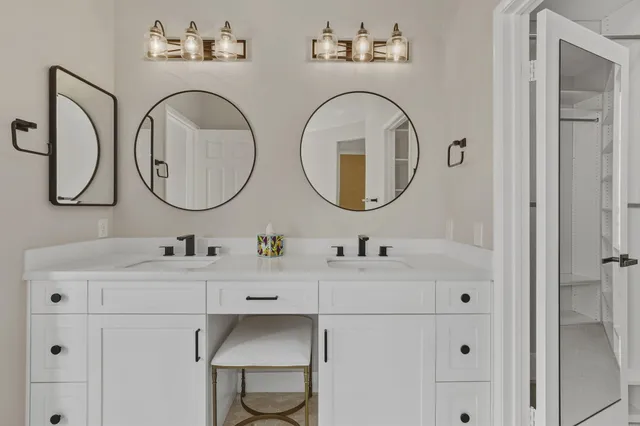 a bathroom with a double vanity sink and a mirror